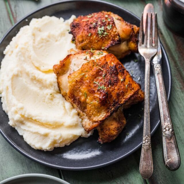 Air Fryer Roasted Chicken Thighs on plate with mashed potatoes