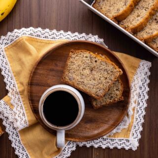 Banana Bread slices on plate with coffee cup