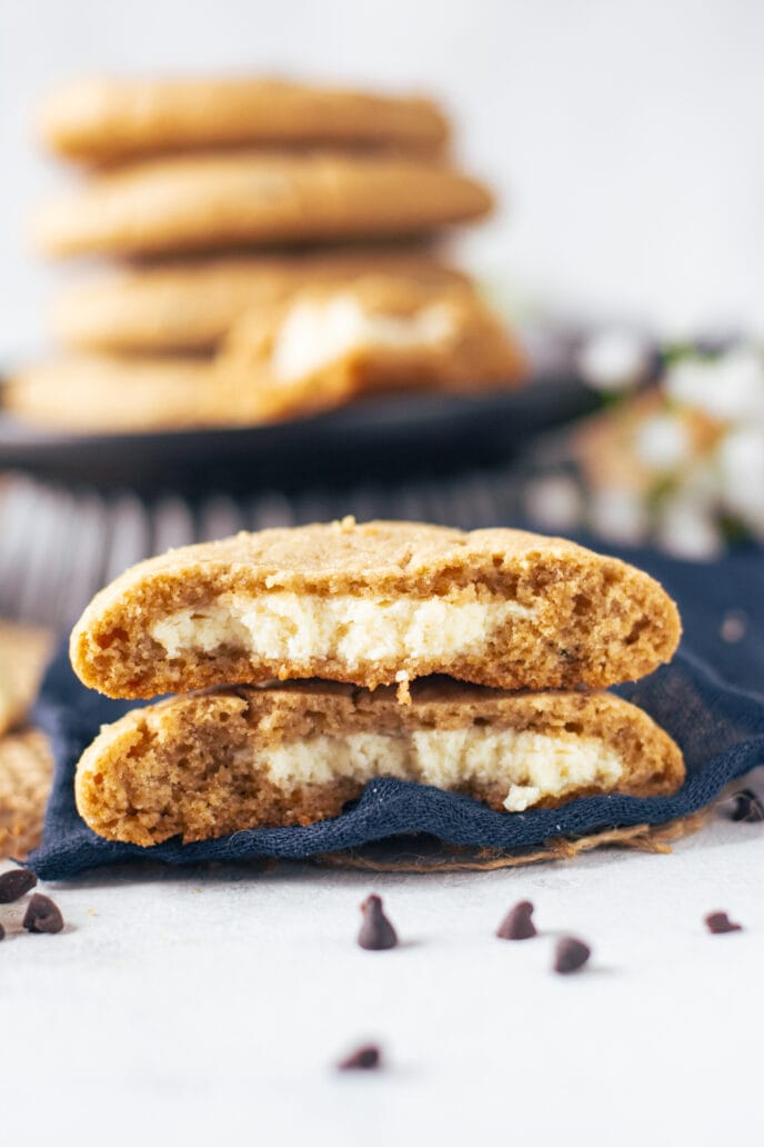 Cheesecake Stuffed Chocolate Chip Cookies baked and two cut in half to see filling