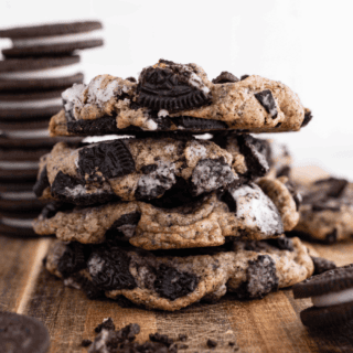 Stack of baked cookies with Oreos stacked in background