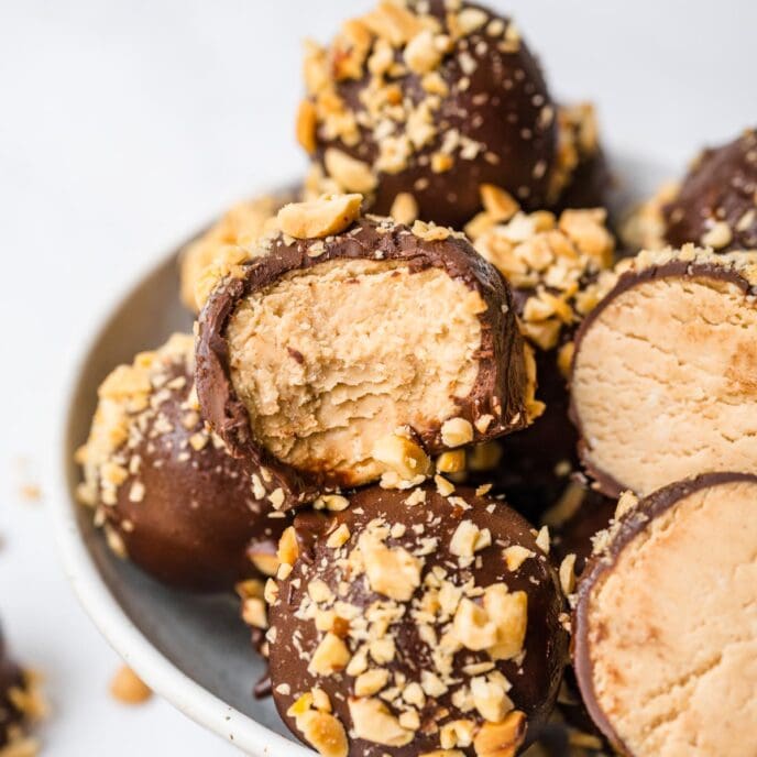 Peanut Butter Truffles In Bowl with Some Truffles with Bites removed