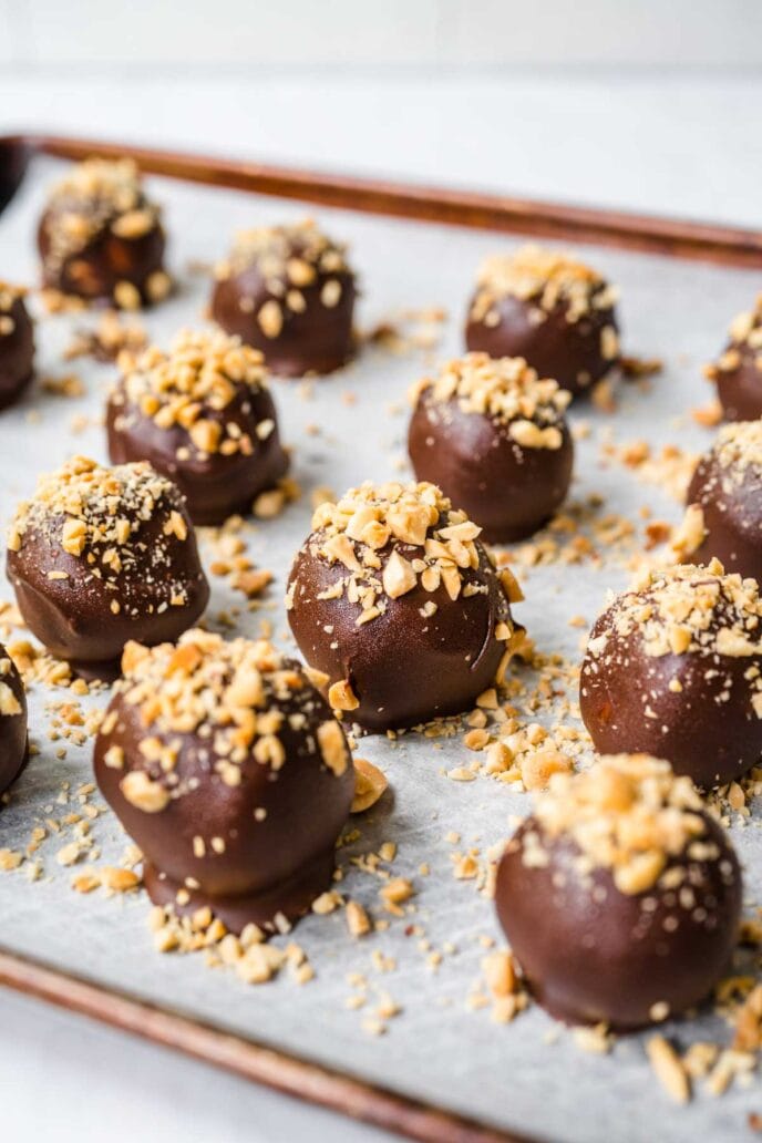 Peanut Butter Truffles with Chocolate Coating and Peanuts Shaped and on baking tray