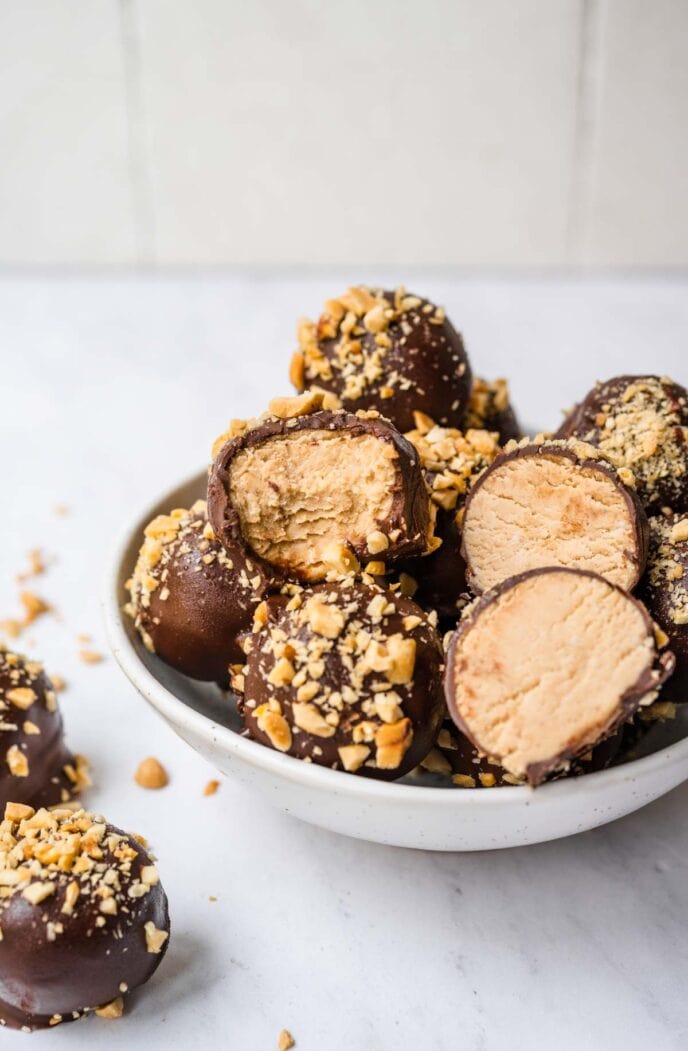 Peanut Butter Truffles In Bowl with Some Truffles with Bites removed
