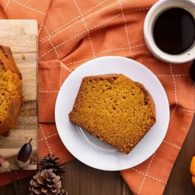 Bread on plate with cup of coffee