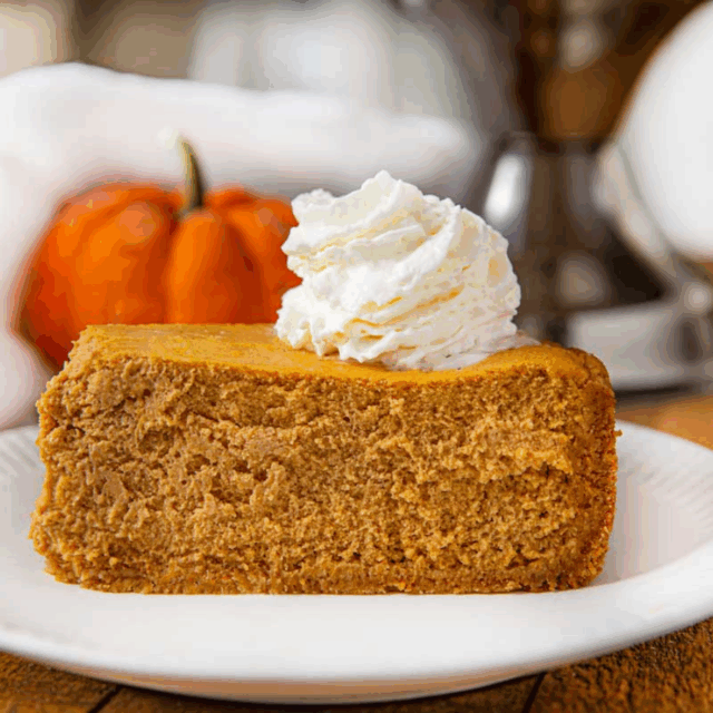 slice of autumn-flavored creamy dessert on a plate with cream on top