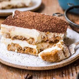 Tiramisu on white plate with fork