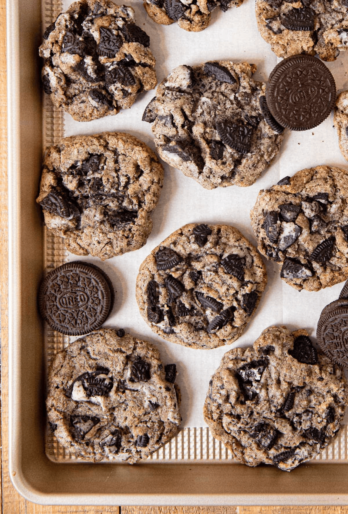 Baked cookies and Oreos on a parchment-lined baking sheet