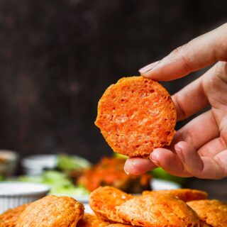 Crackers on serving plate with hand picking one up
