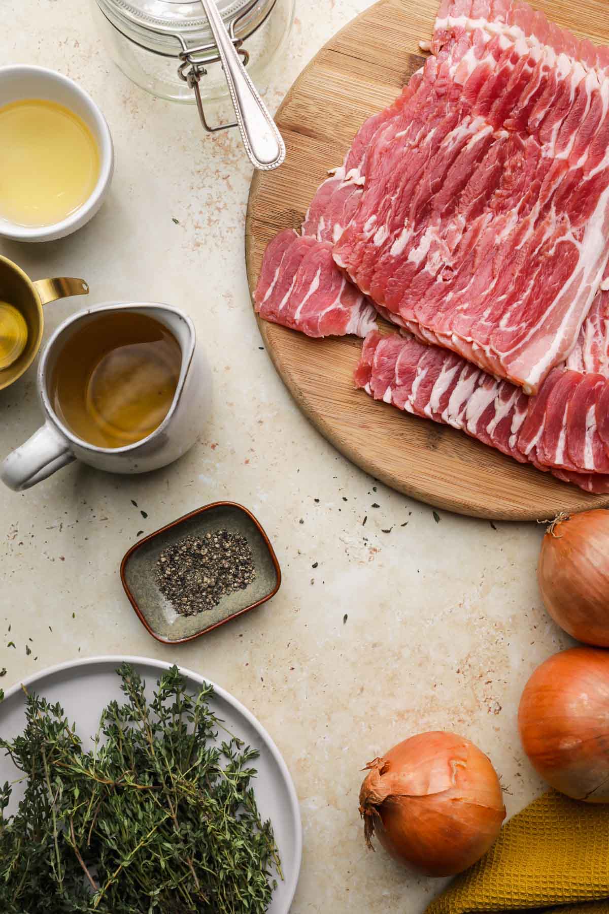 Bacon Jam ingredients in dishes and bacon on cutting board