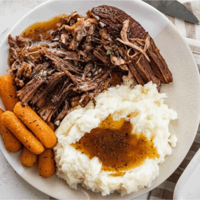 Served on plate with potatoes and carrots