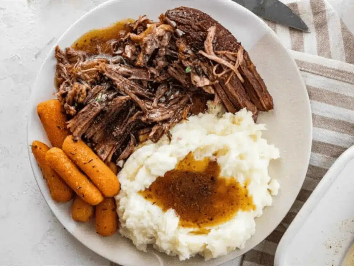 Mashed potatoes, carrots, and beef on a plate