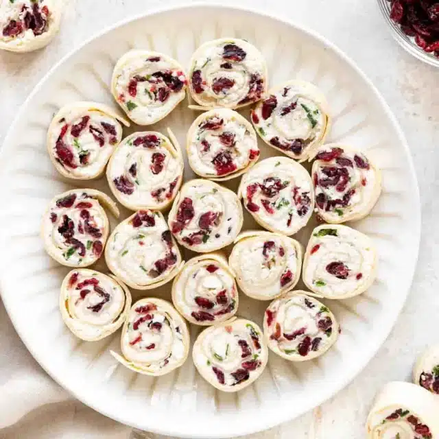Top view of tortillas rolled with spread inside on a plate