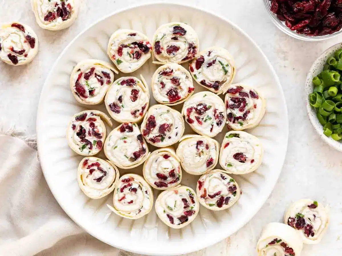 Top view of tortillas rolled with spread inside on a plate