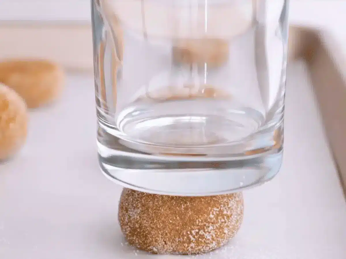 Dough ball flattened with water glass