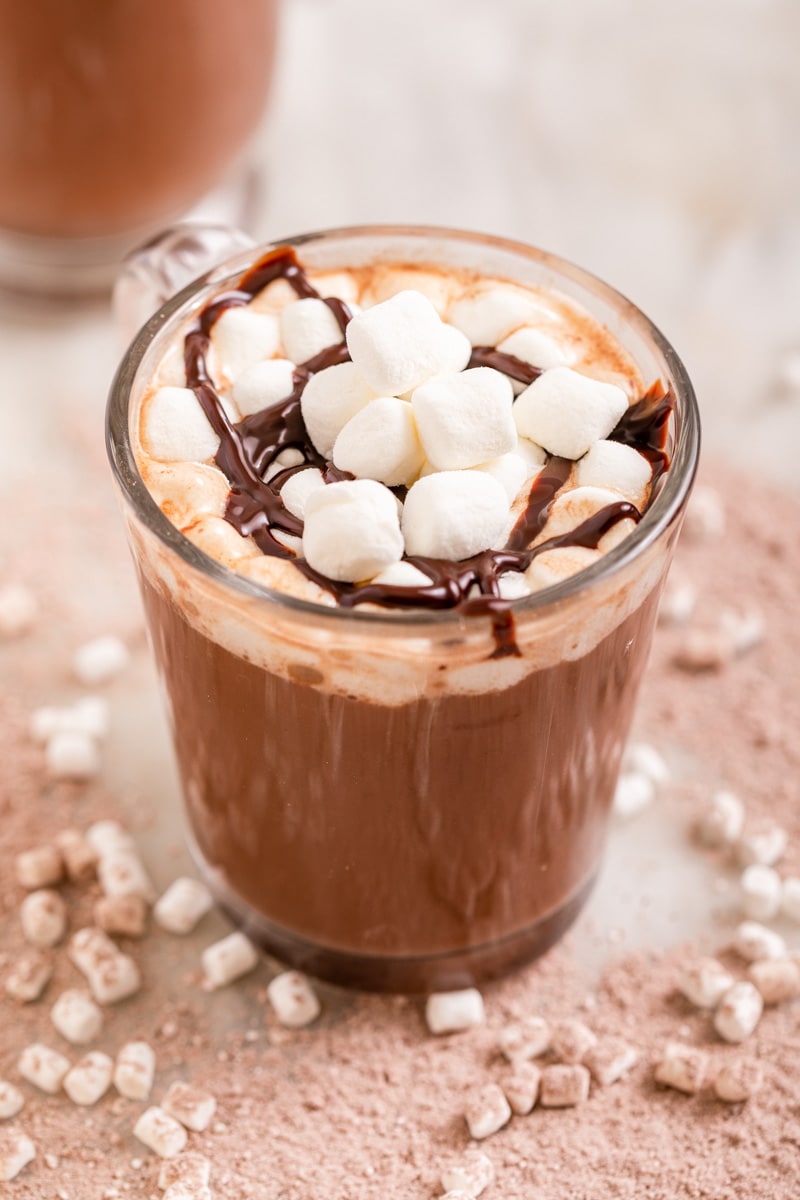 Hot Chocolate Mix Prepared in Glass Mug with Marshmallows and Chocolate Sauce