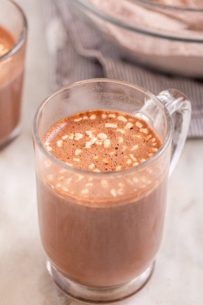 Hot Chocolate Mix ingredients in glass mug with water mixed