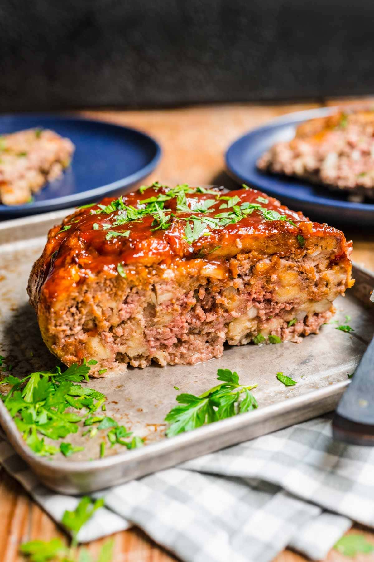 Instant Pot Meatloaf portion on metal tray with garnish