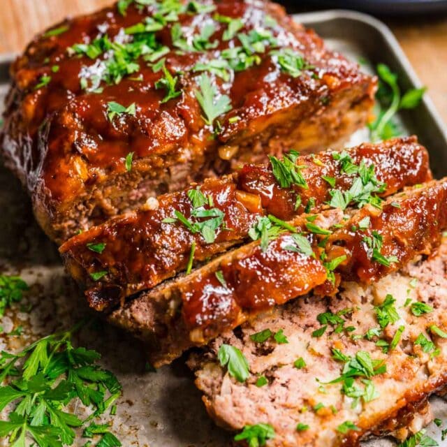 Instant Pot Meatloaf finished with glaze and garnish sliced on tray