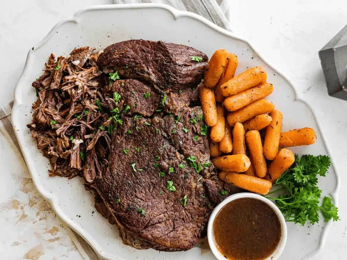 Beef roast on a plate with carrots
