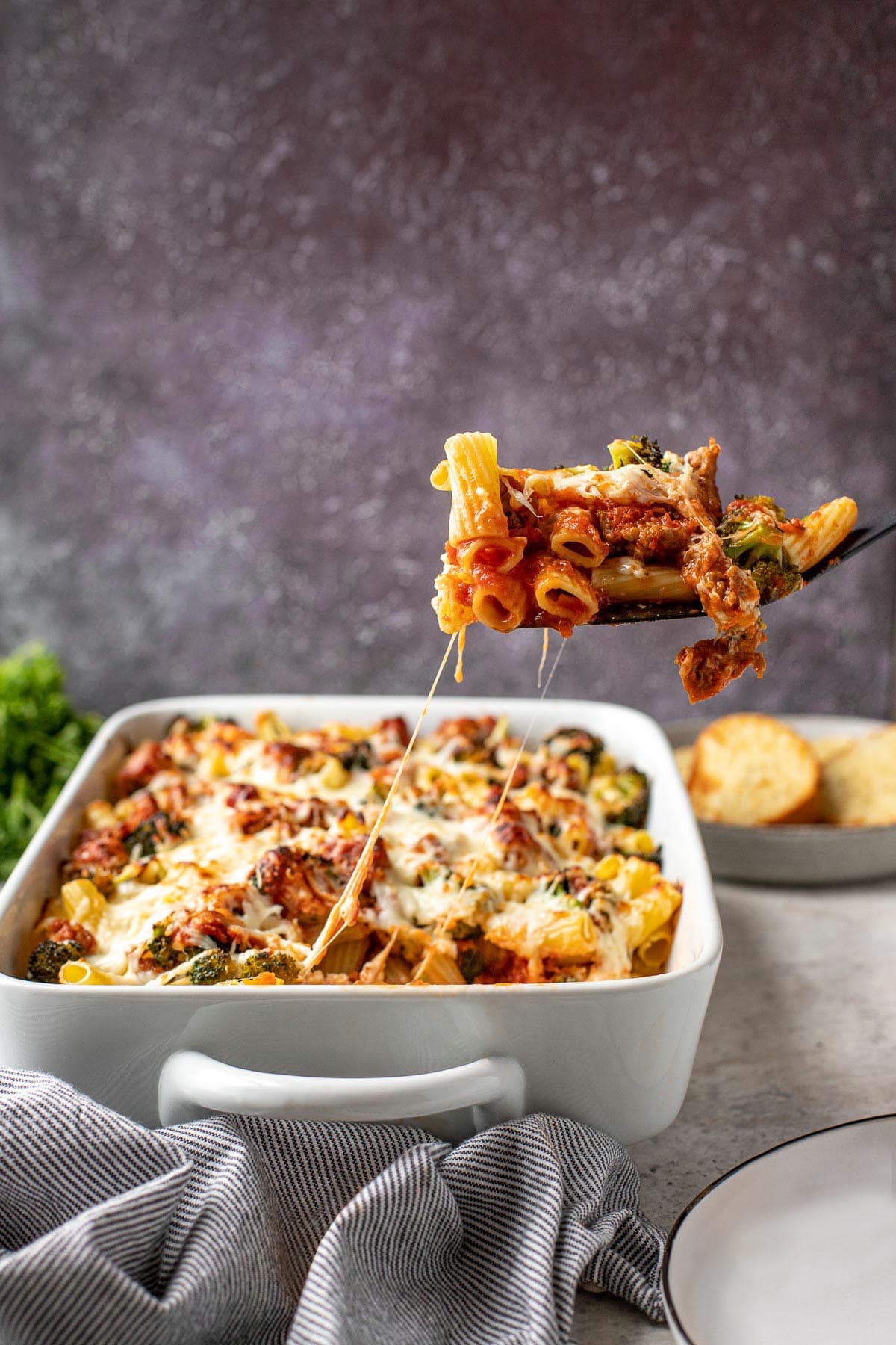 Baked Rigatoni in baking dish with spatula serving