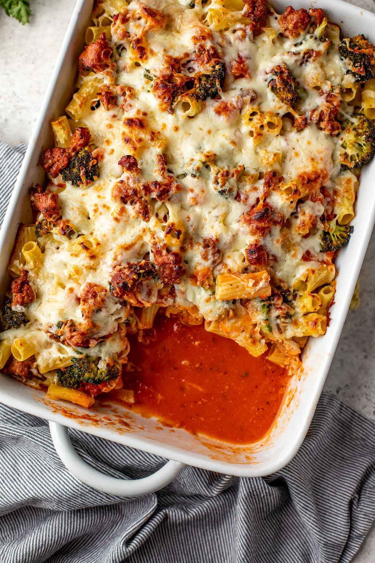 Baked Rigatoni in baking dish with spatula serving