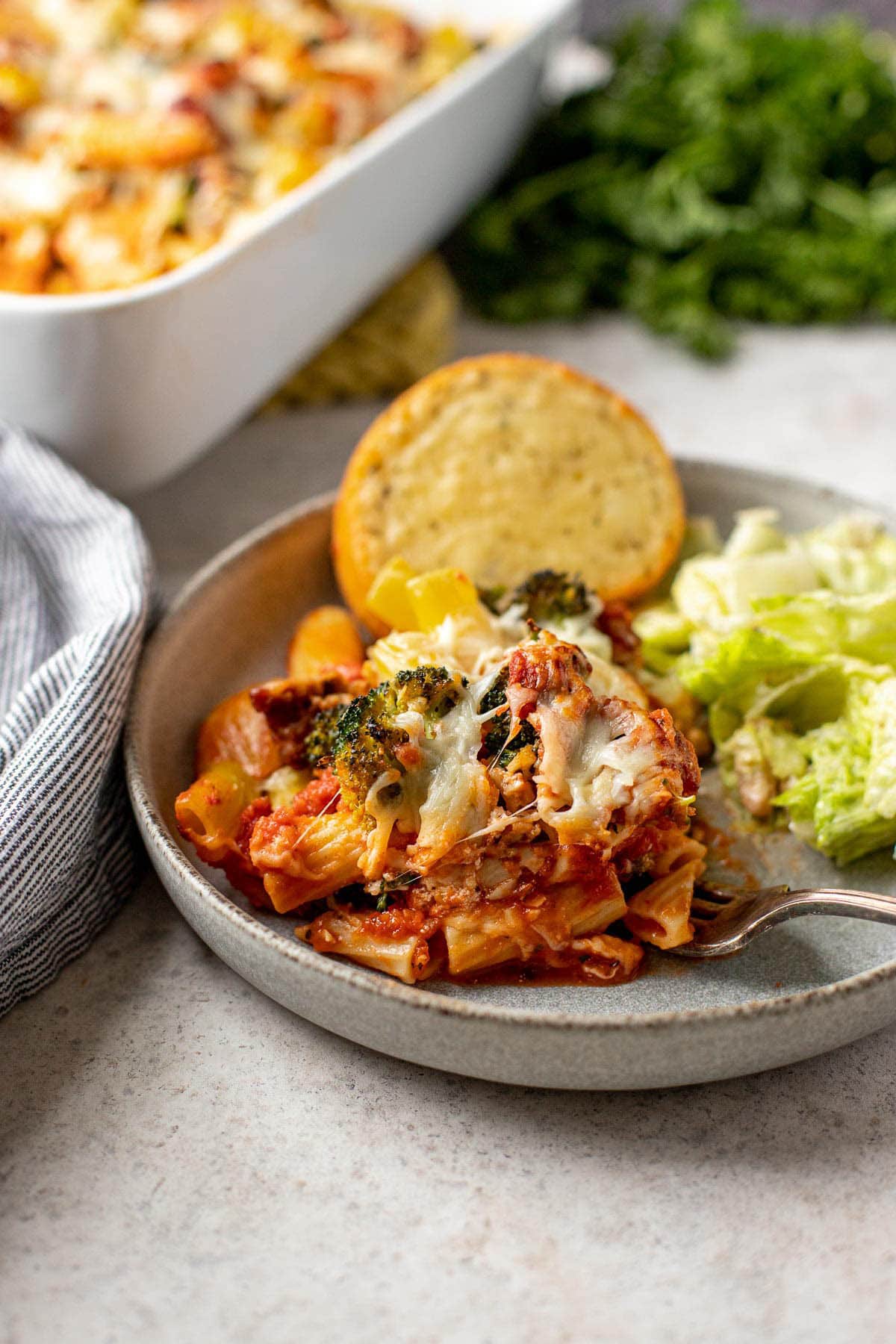 Baked Rigatoni in baking dish with spatula serving