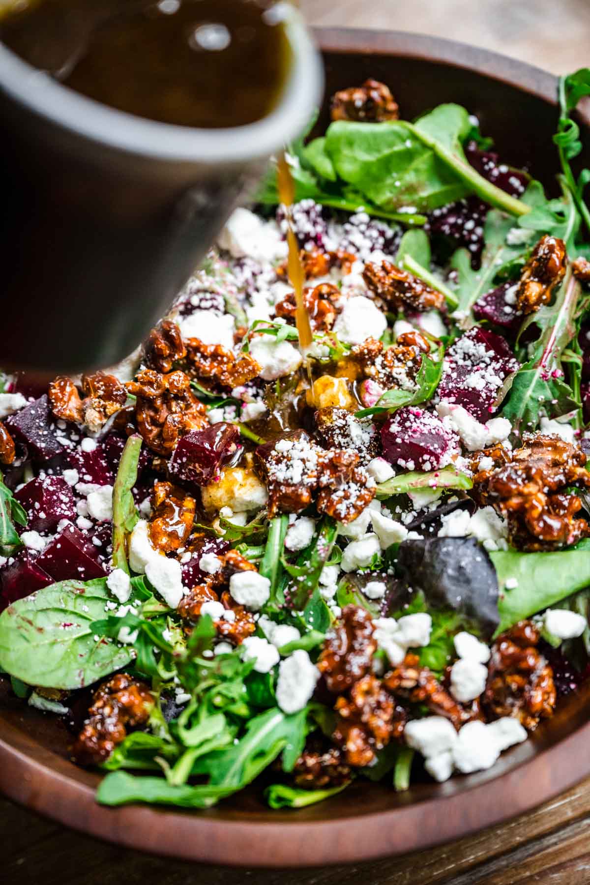 Beet and Goat Cheese Salad pouring dressing close up