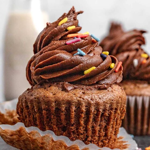 Cupcakes frosted with wrapper partially removed