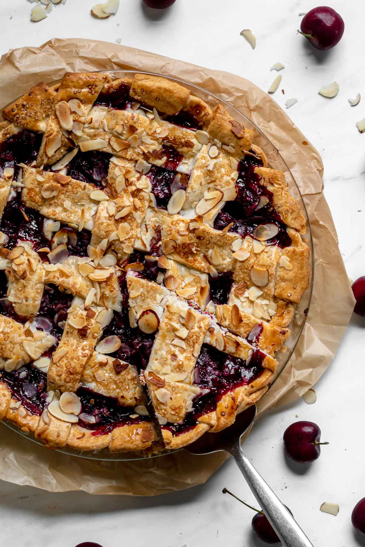 Cherry Almond Pie in pie dish with slice cut but not removed.