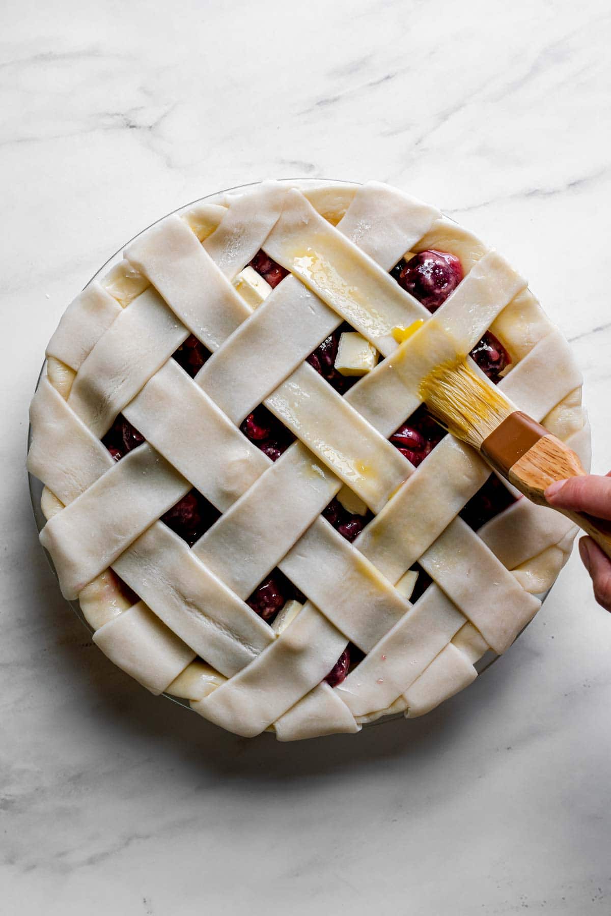 Cherry Almond Pie unbaked adding egg wash to lattice crust