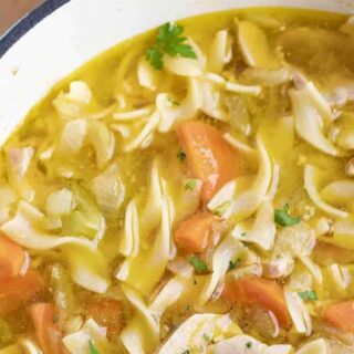Soup in a white bowl, ready to eat.