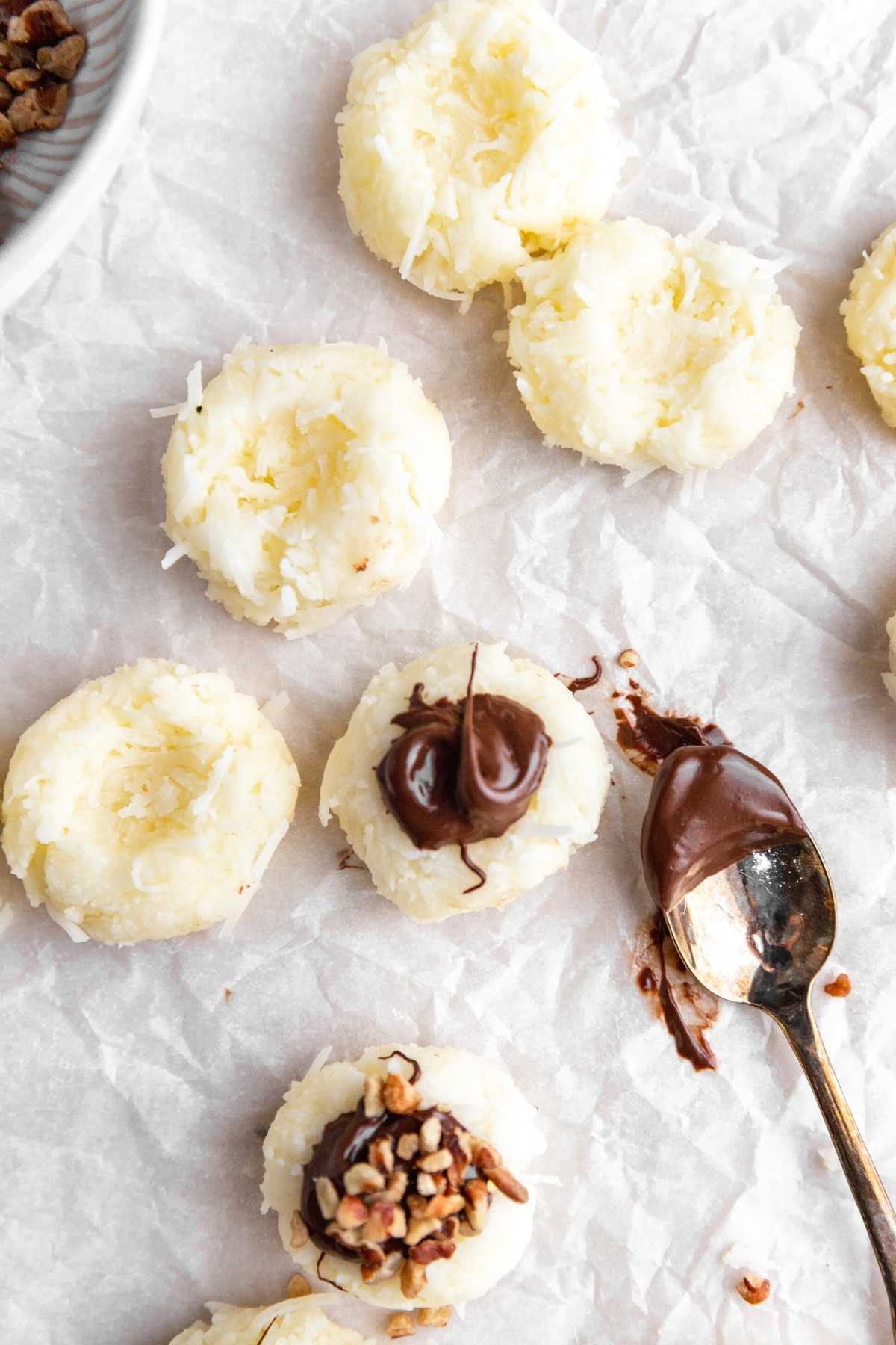 Coconut Joy Candies adding chocolate to coconut bites