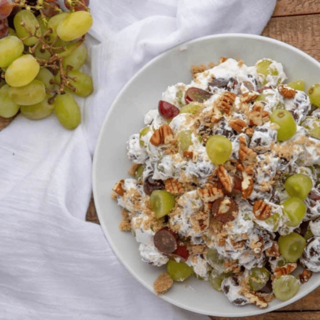 Grapes next to salad in bowl