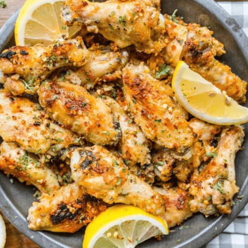 Wings on plate with lemon garnish