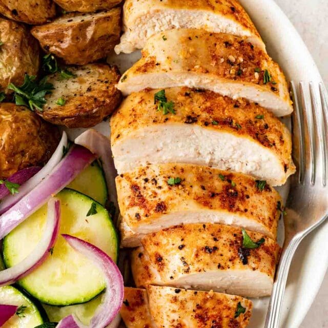 Oven Baked Chicken Breasts sliced on plate