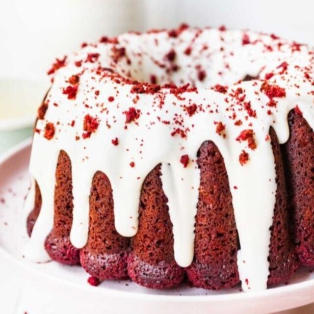 Full bundt cake with frosting and crumb topping