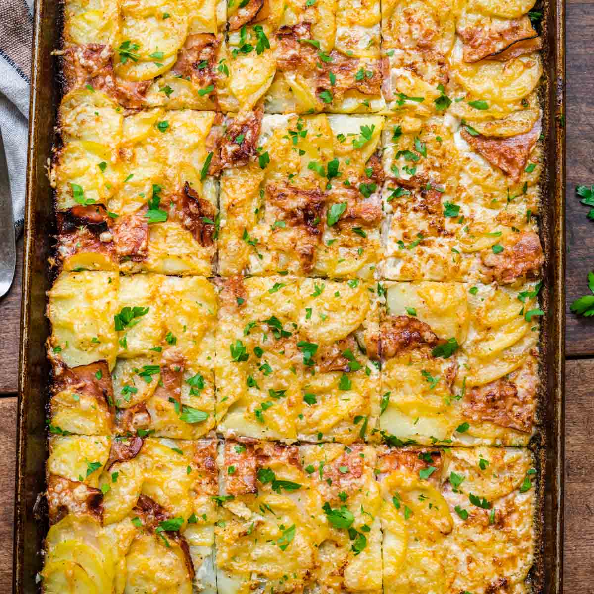 Sheet Pan Ham and Swiss Scalloped Potatoes finished and cut on pan