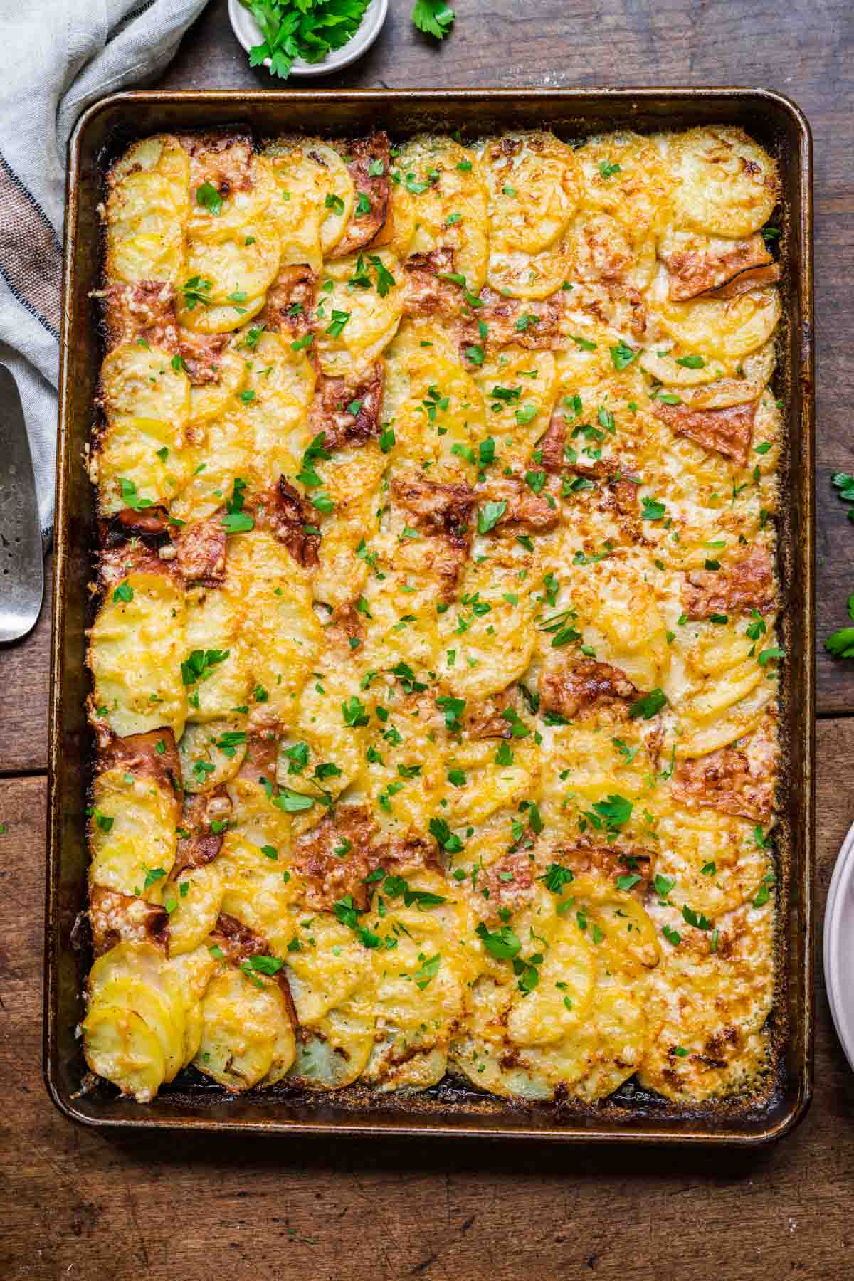 Sheet Pan Ham and Swiss Scalloped Potatoes finished and cut on pan