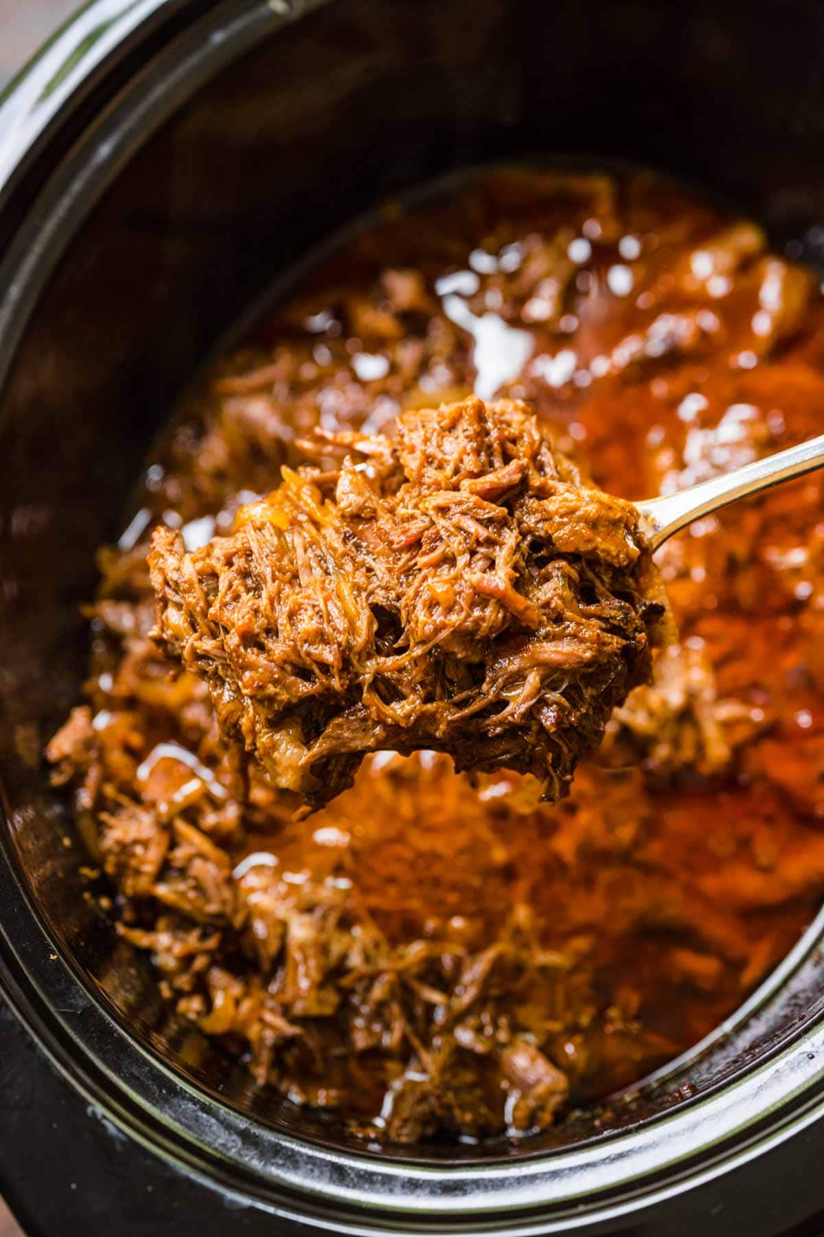 Slow Cooker Shredded Beef shredded in slow cooker and on fork