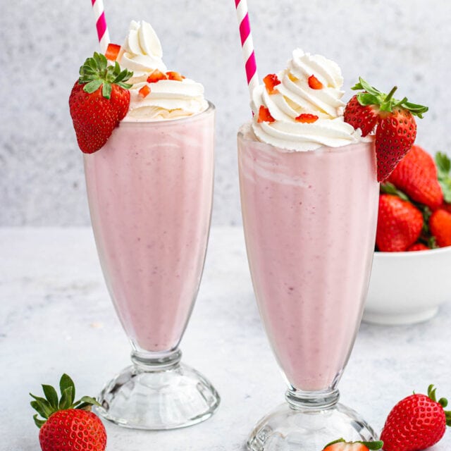 Strawberry Milkshake in glasses with straws
