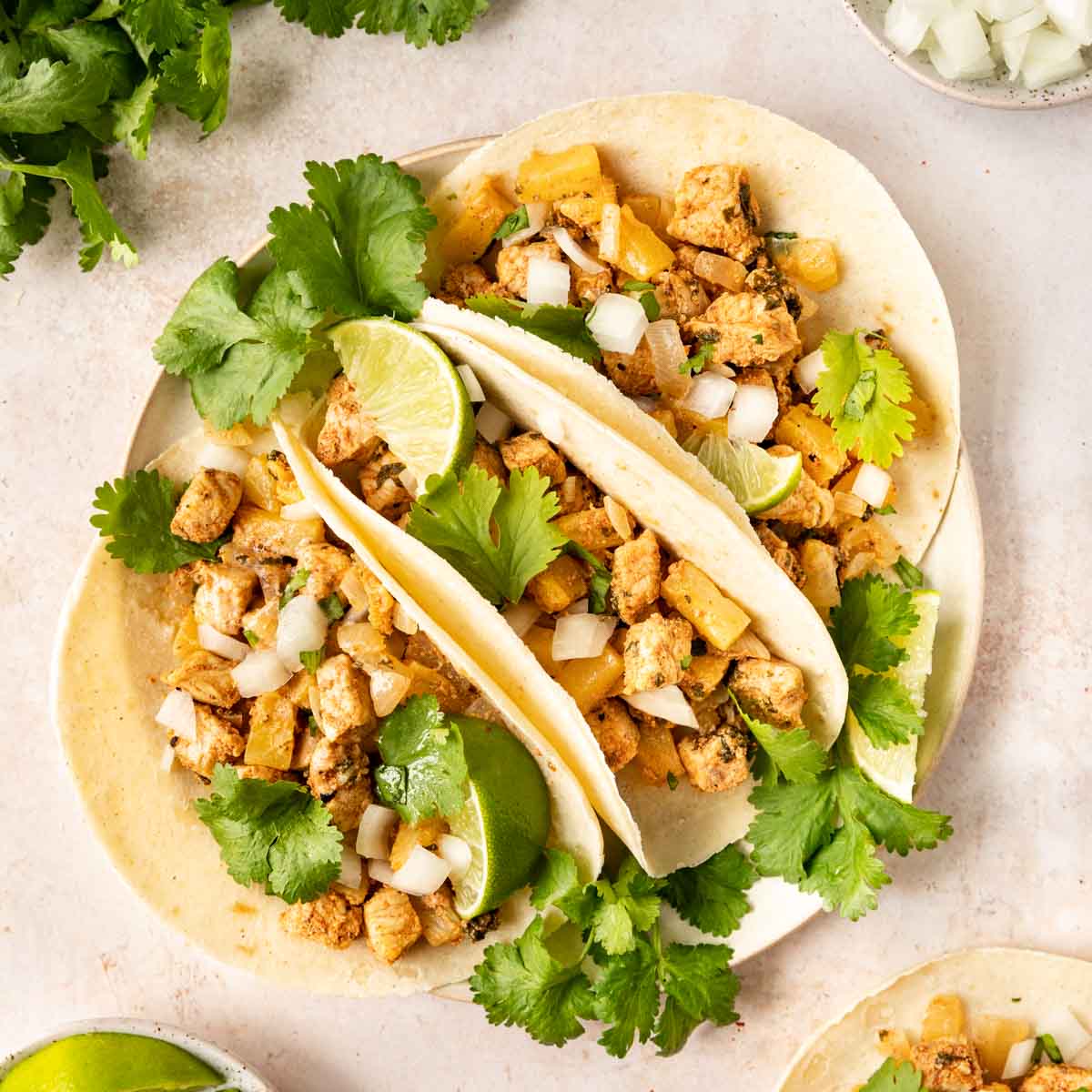 Tacos Al Pastor finished on tortillas with garnish