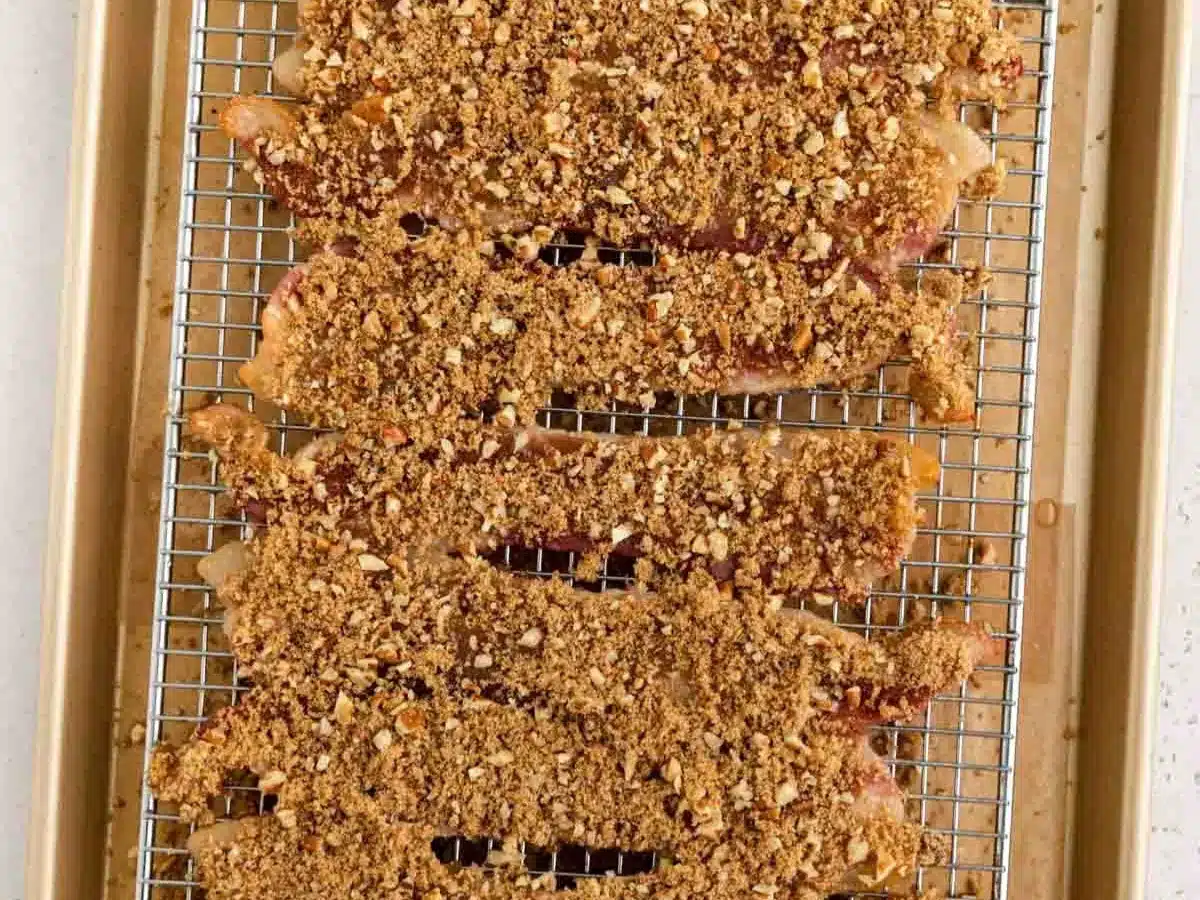 Thin strips of cured pork coated in brown sugar and nuts.