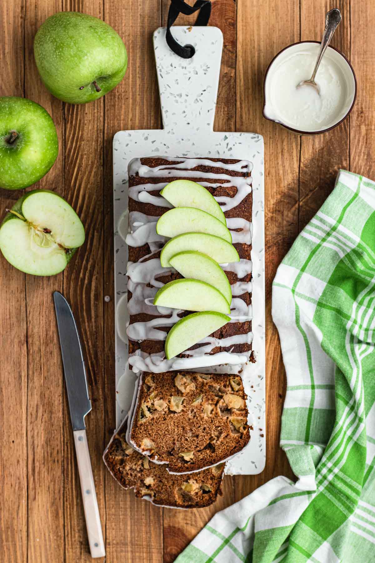 Apple Bread sliced on serving board with apple slices on top