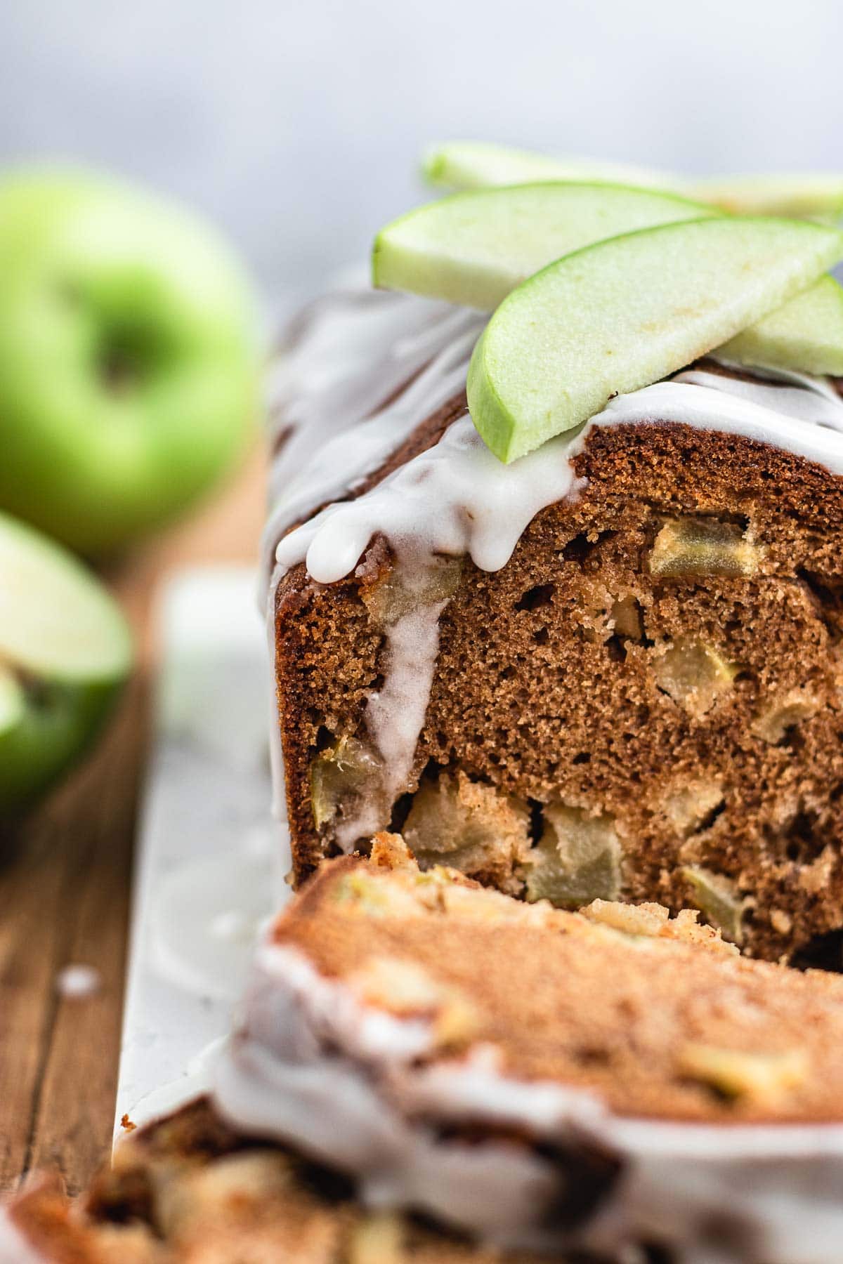 Apple Bread sliced on serving board with apple slices on top