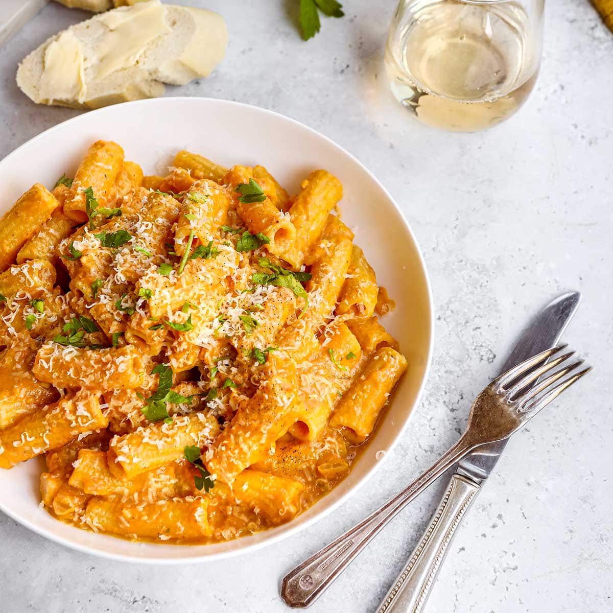 Creamy Pumpkin Pasta in bowl topped with Parmesan cheese and parsley