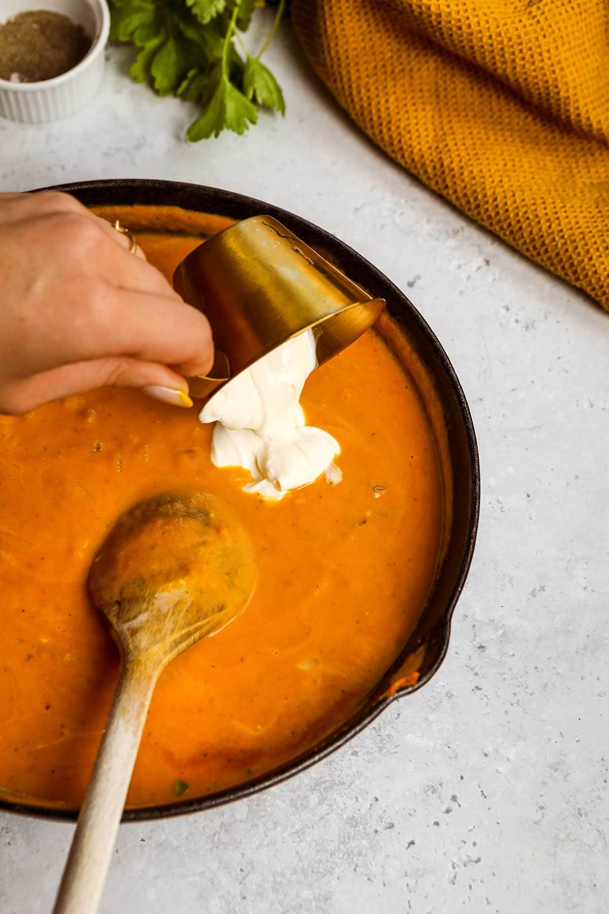 Creamy Pumpkin Pasta sauce in pot adding cream