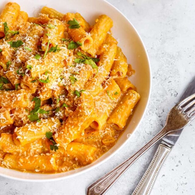 Creamy Pasta in bowl topped with Parmesan cheese and parsley