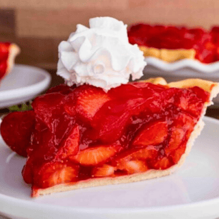 slice on a white plate with whipped cream