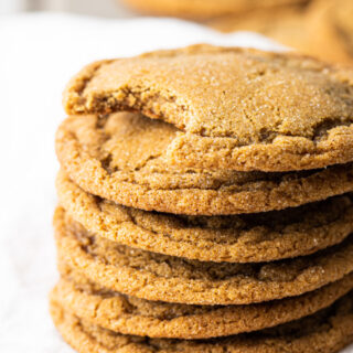 Stack of cookies with the one on top missing a bite.