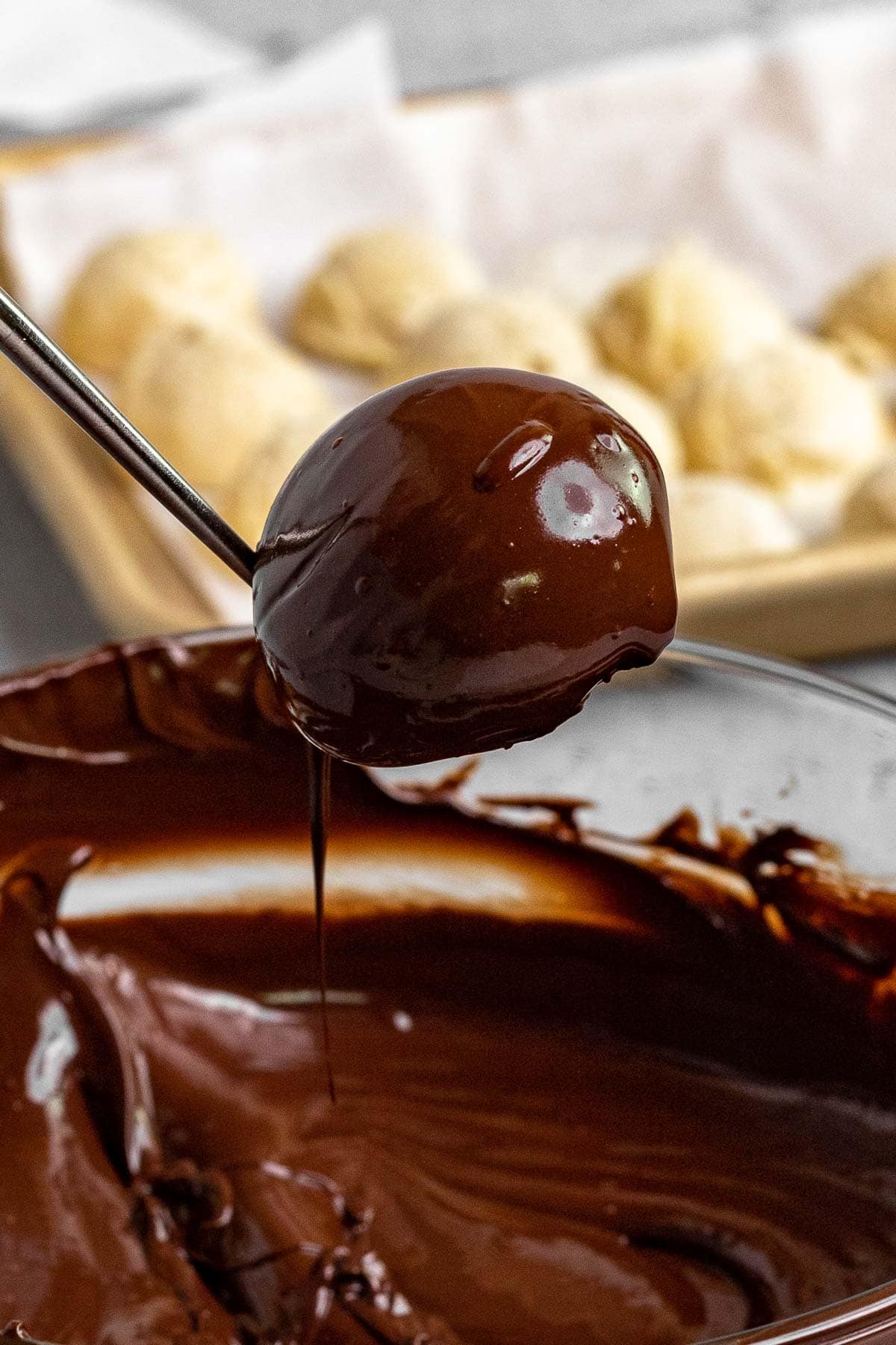 Ice Cream Bon Bons dipping ice cream scoop in chocolate